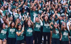 Estudiantes con playeras verdes animan desde las gradas durante la inauguración de los Juegos Universitarios en el Estadio Olímpico Universitario