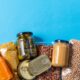 eating, charity and donation concept - close up of different packed food on blue background